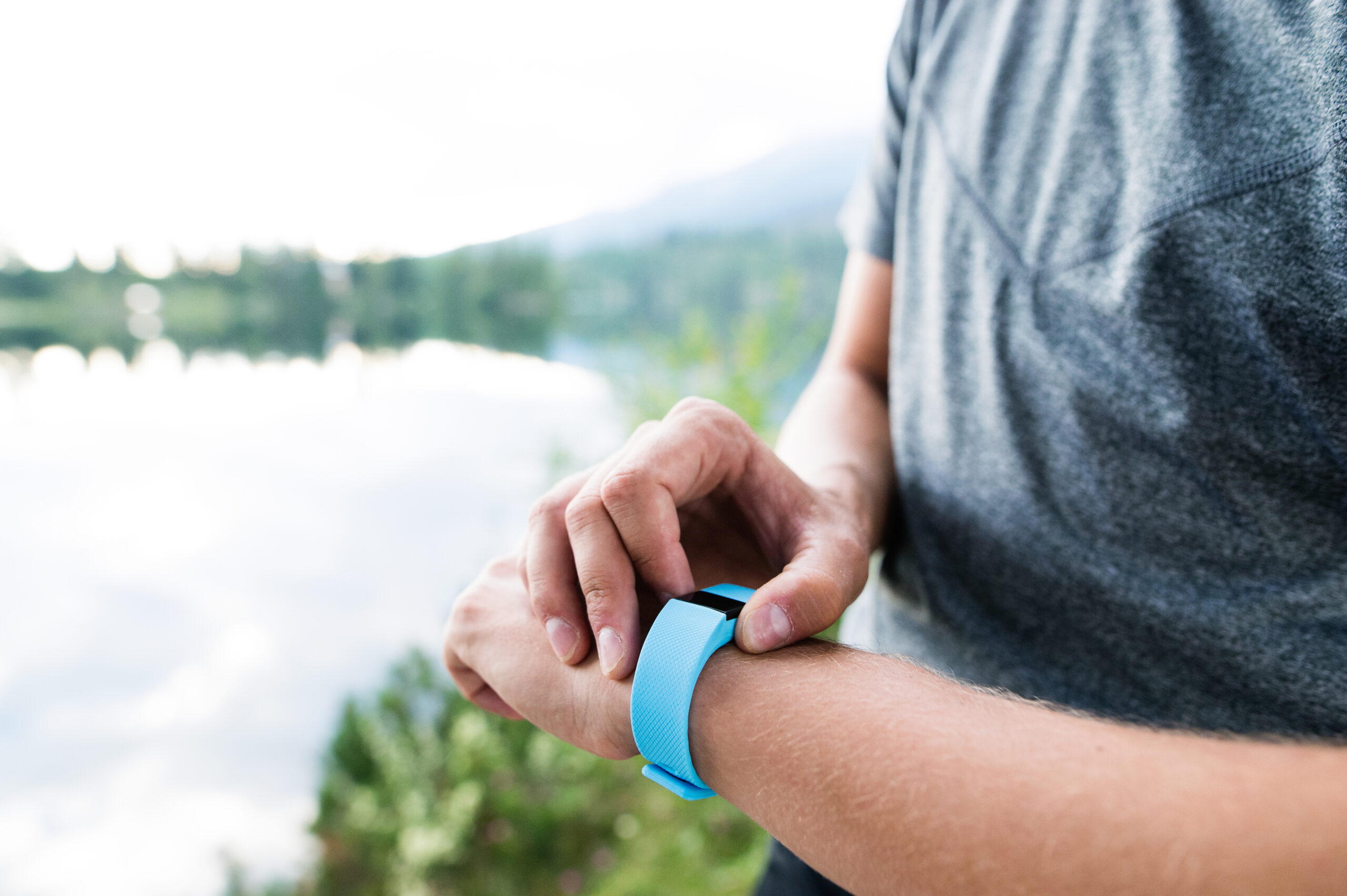 graphicstock close up of unrecognizable runner at the lake in green nature wearing smartwatch using a fitness app for tracking weight loss progress running goal or summary of his run Bubh5y6rGW scaled